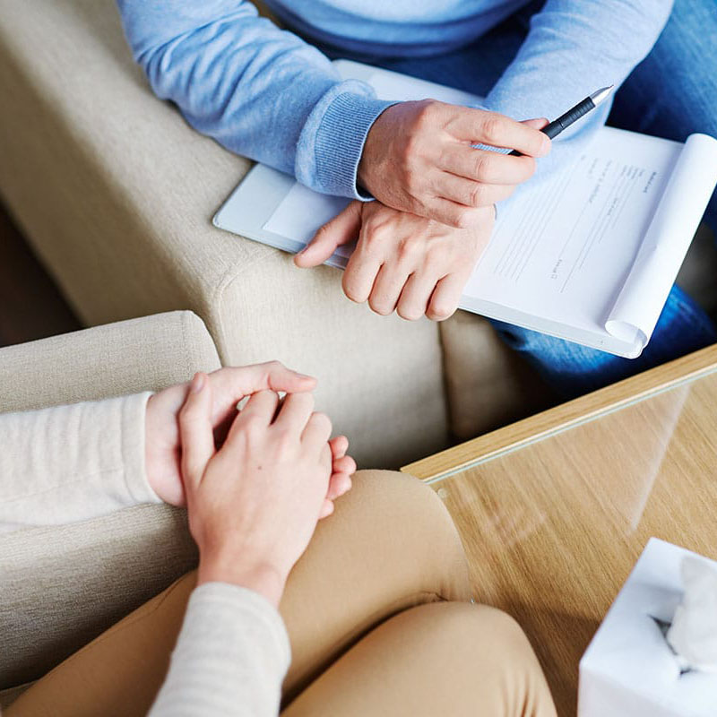 the hands of a patient and a therapist in an outpatient addiction treatment