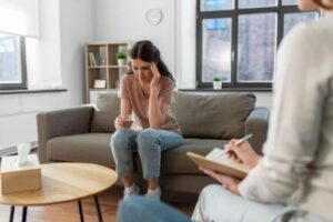 a person talks to a therapist in a trauma therapy program
