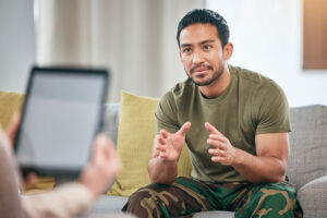 a veteran talks to a therapist during a veterans program